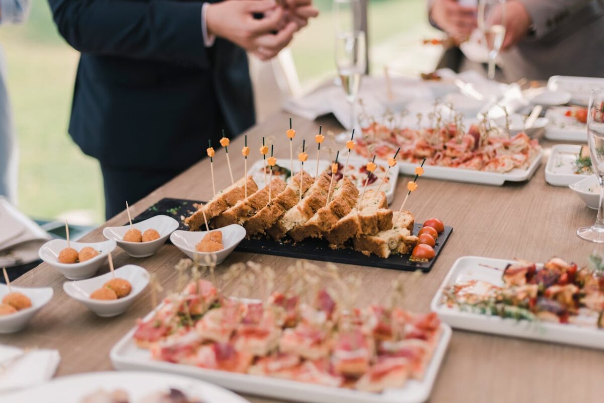 A variety of appetizers displayed elegantly on a buffet table at a social event.