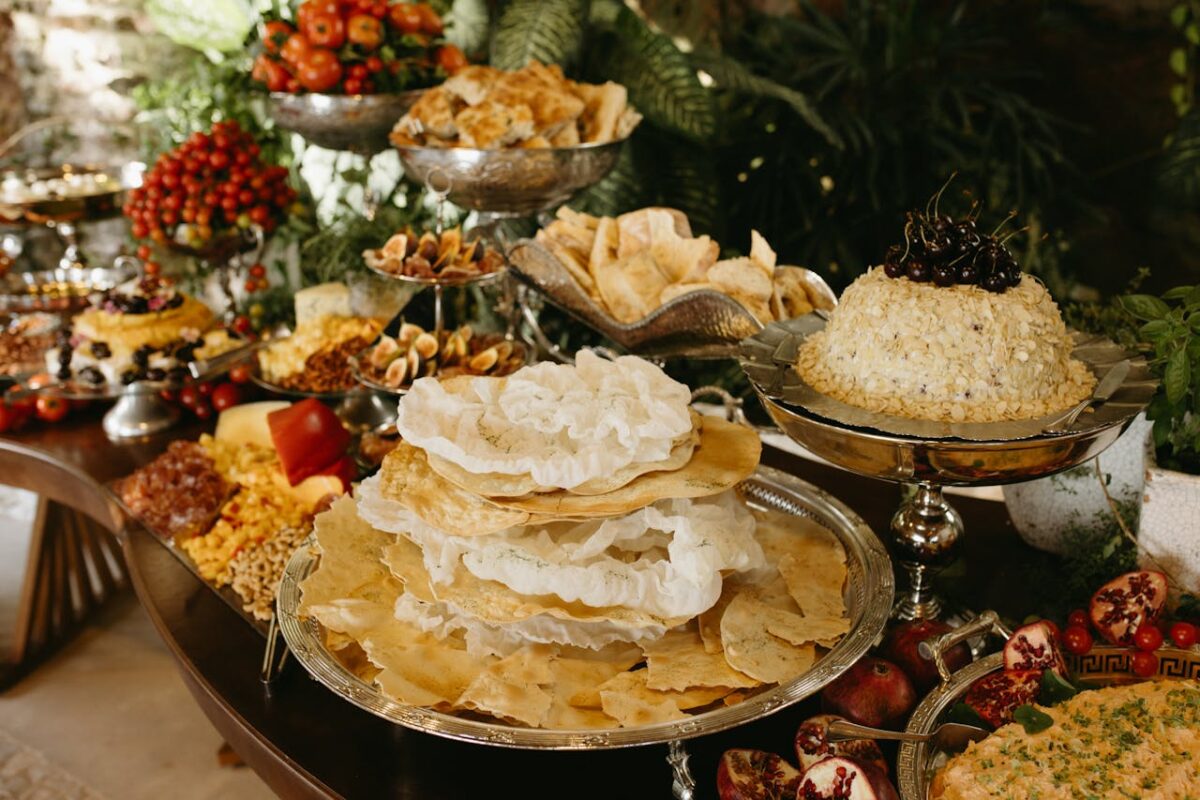 A lavish buffet featuring an array of gourmet dishes including flatbreads, cheeses, and fruits, set in an elegant indoor setting.